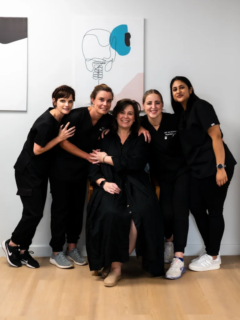 Friendly physiotherapy team supporting patients through rehabilitation after spine surgery.
