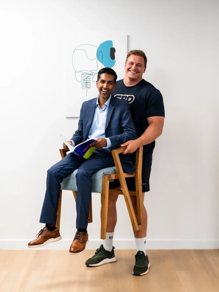 Rayno Nel and Dr Jaytesh Pillay sharing a light-hearted moment during a patient success story consultation