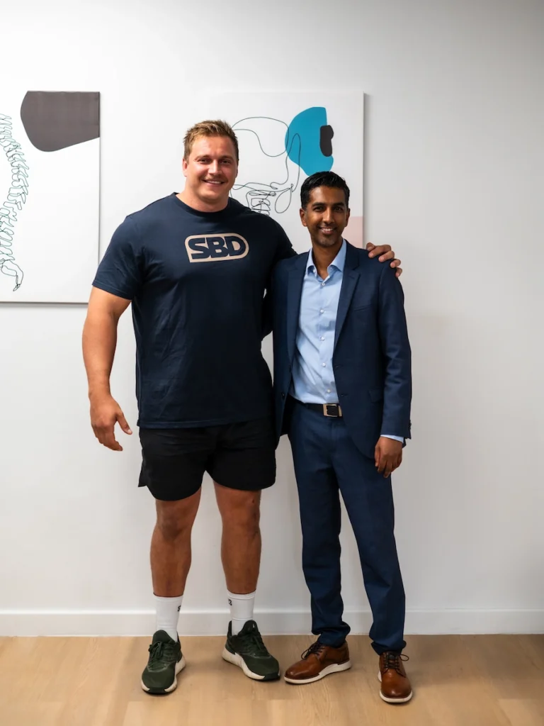 Rayno Nel, 2025 World's Strongest Man champion, with spine surgeon Dr Jaytesh Pillay following specialist spine care